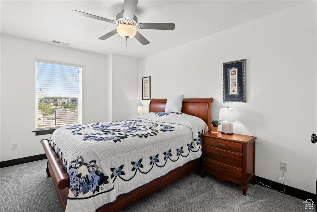 Carpeted bedroom featuring ceiling fan