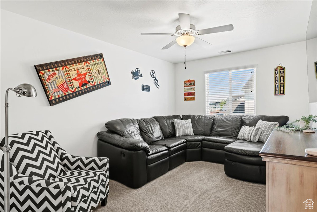 Living room featuring carpet flooring and ceiling fan