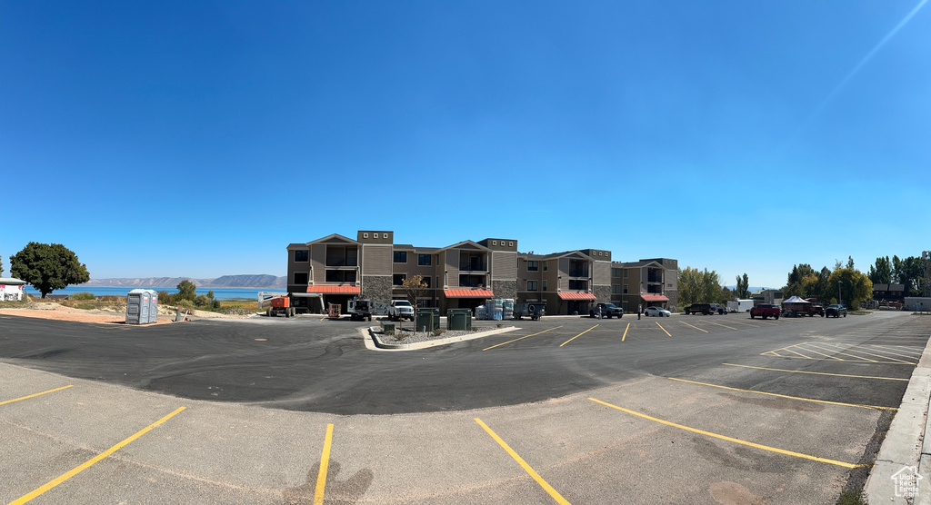 View of parking with a water view