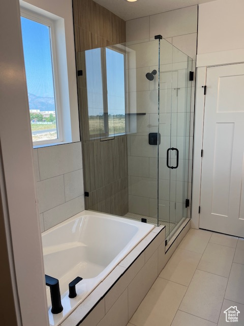 Bathroom with tile patterned flooring and plus walk in shower