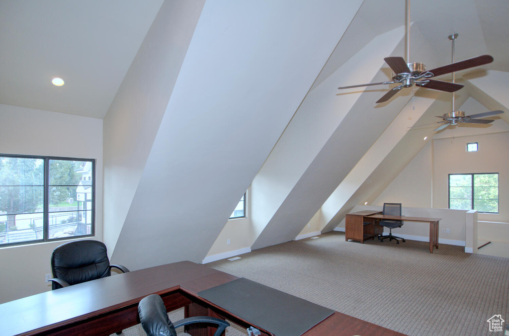 Office area with high vaulted ceiling, ceiling fan, and carpet