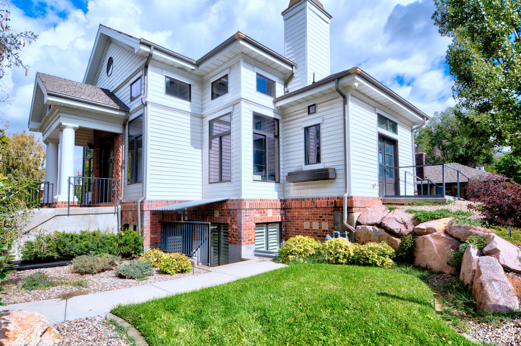 View of side of property featuring a yard