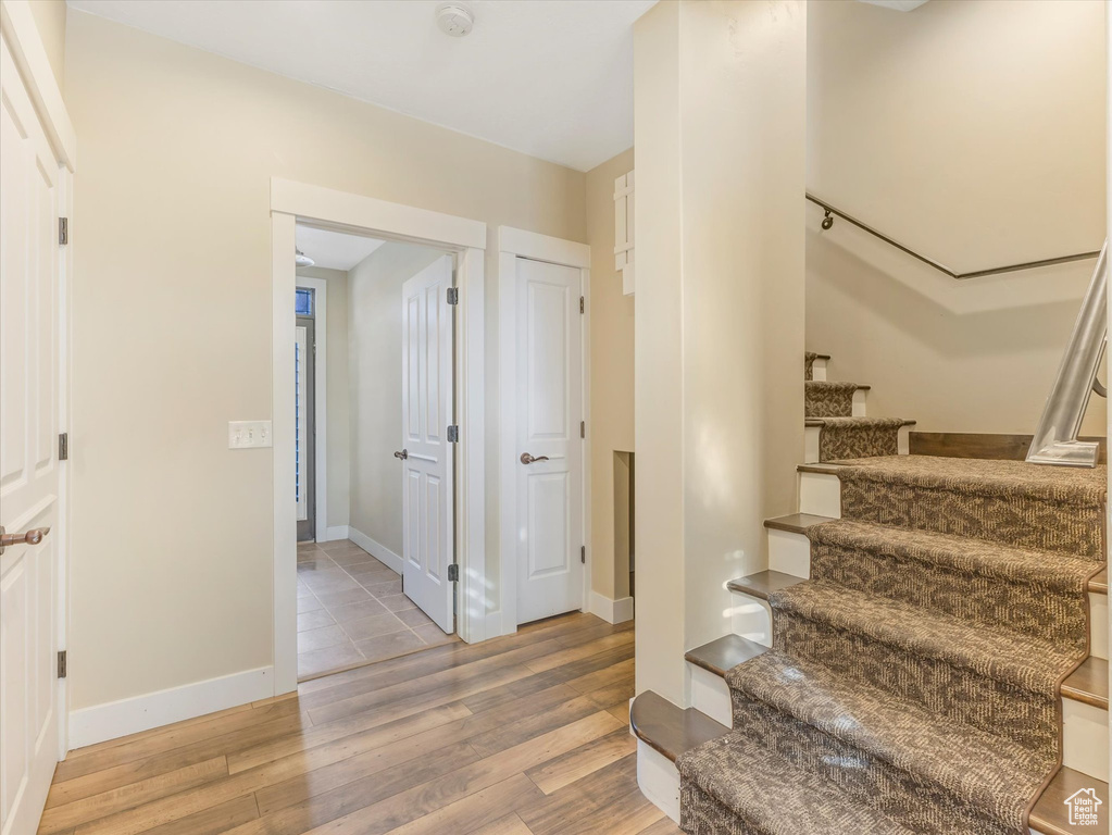 Staircase featuring hardwood / wood-style flooring