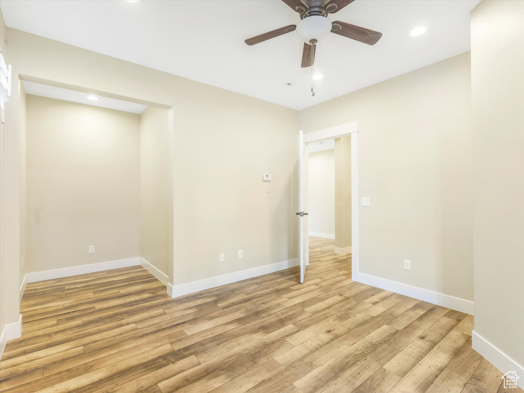 Unfurnished room featuring ceiling fan and light wood-type flooring