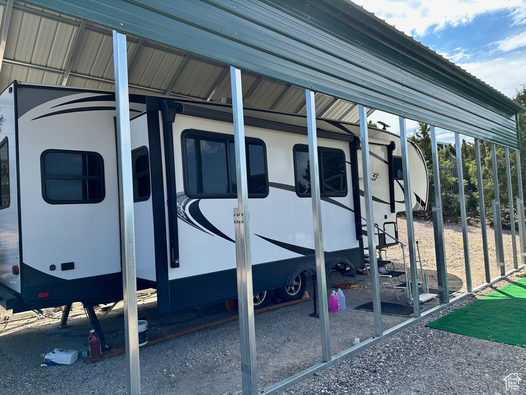 View of parking featuring a carport