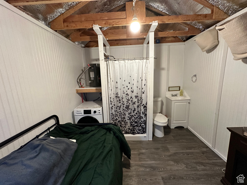 Bedroom featuring sink, wood walls, dark hardwood / wood-style flooring, and vaulted ceiling with beams