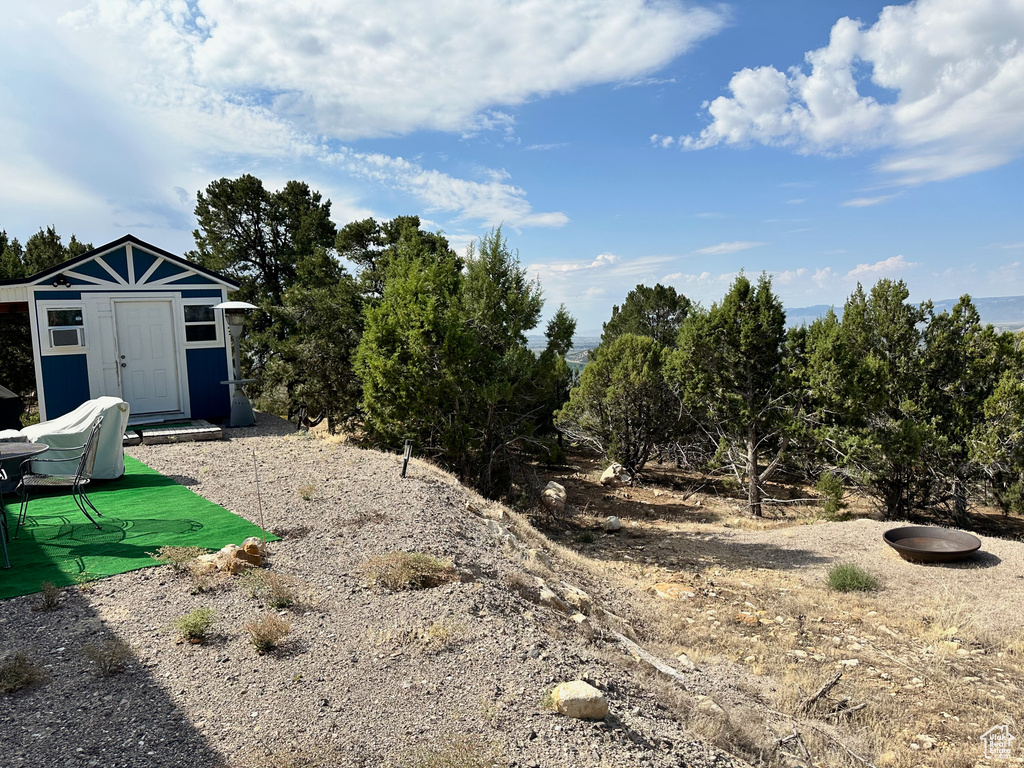 View of yard with a storage unit
