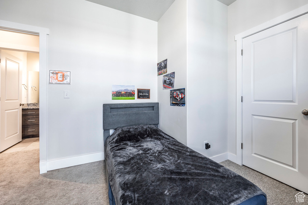 Bedroom featuring light colored carpet