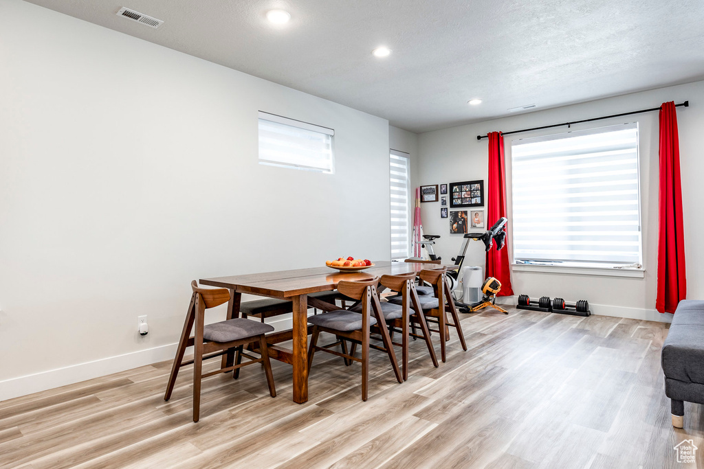 Dining space featuring recessed lighting, light wood-style floors, and baseboards