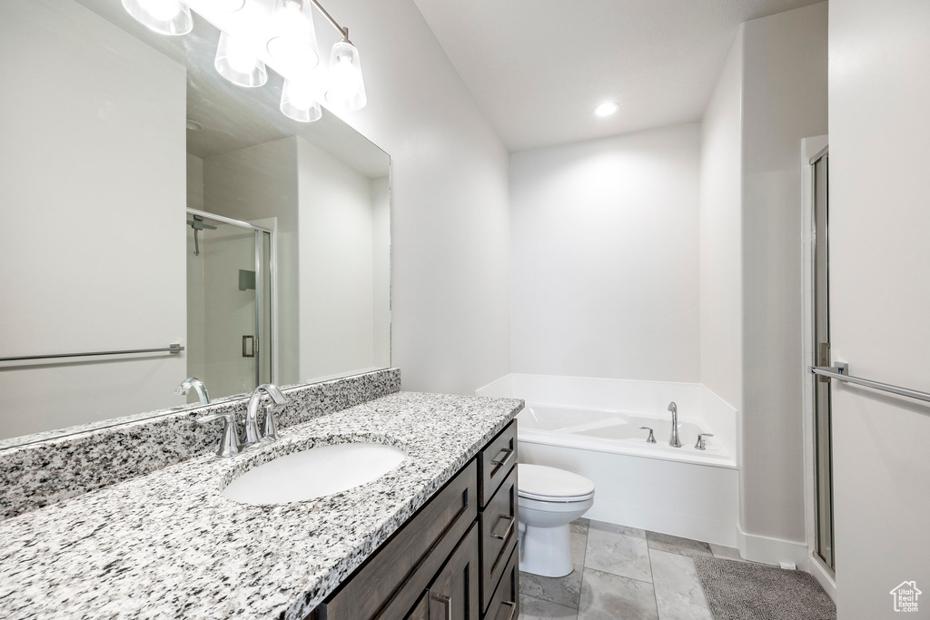 Full bathroom with toilet, vanity, separate shower and tub, and tile patterned flooring