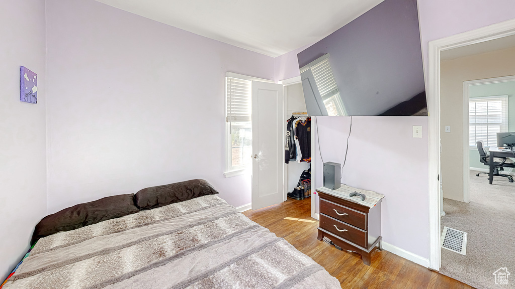 Bedroom with light hardwood / wood-style flooring