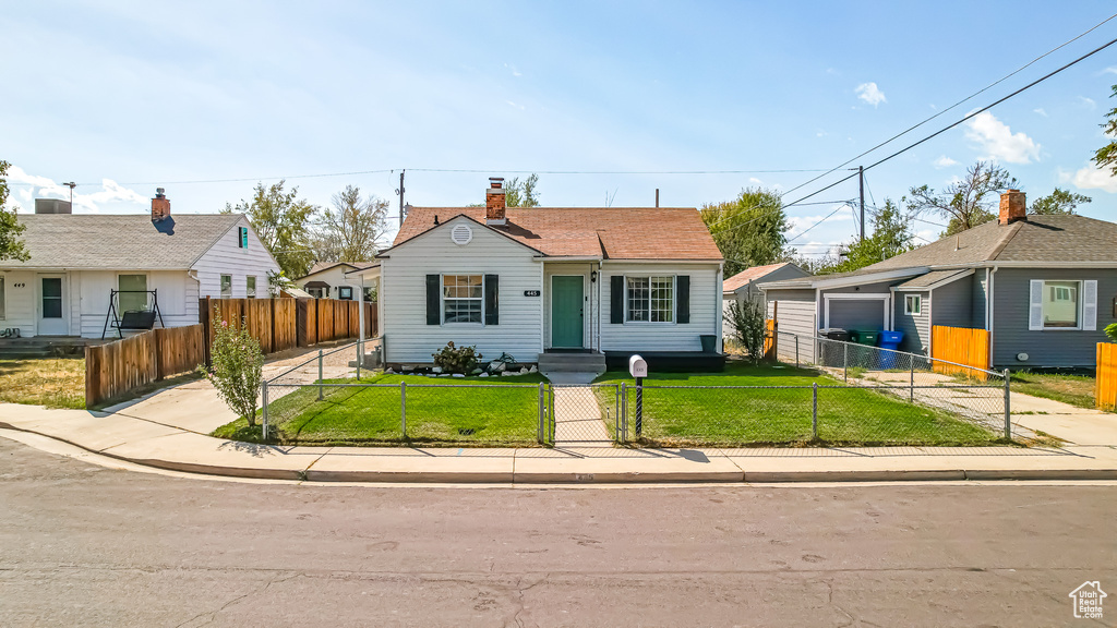 Bungalow-style house with a front yard