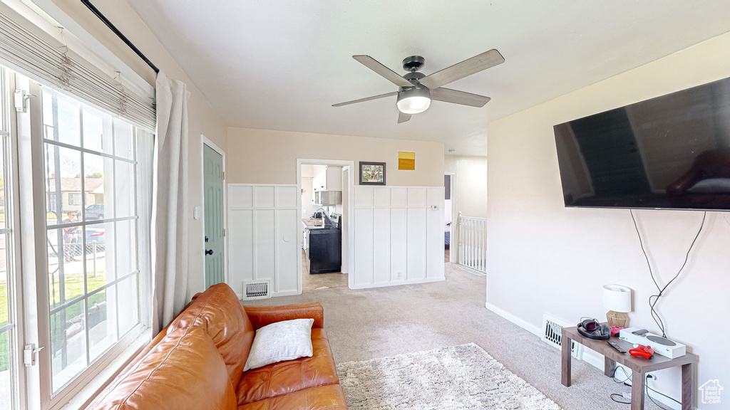 Living room featuring ceiling fan and light colored carpet