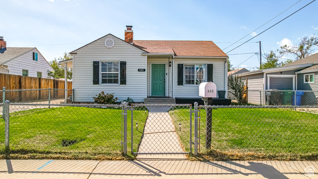 Bungalow-style house with a front yard