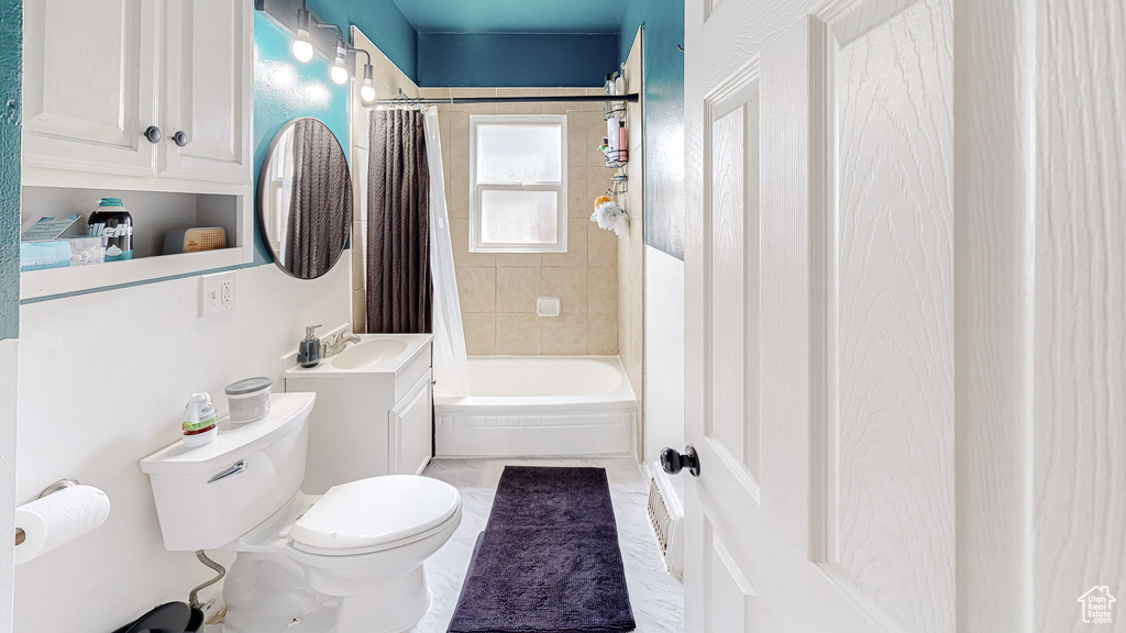 Full bathroom with vanity, toilet, and shower / tub combo with curtain