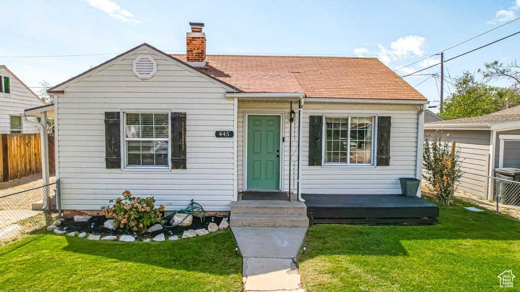 Bungalow-style home with a front lawn