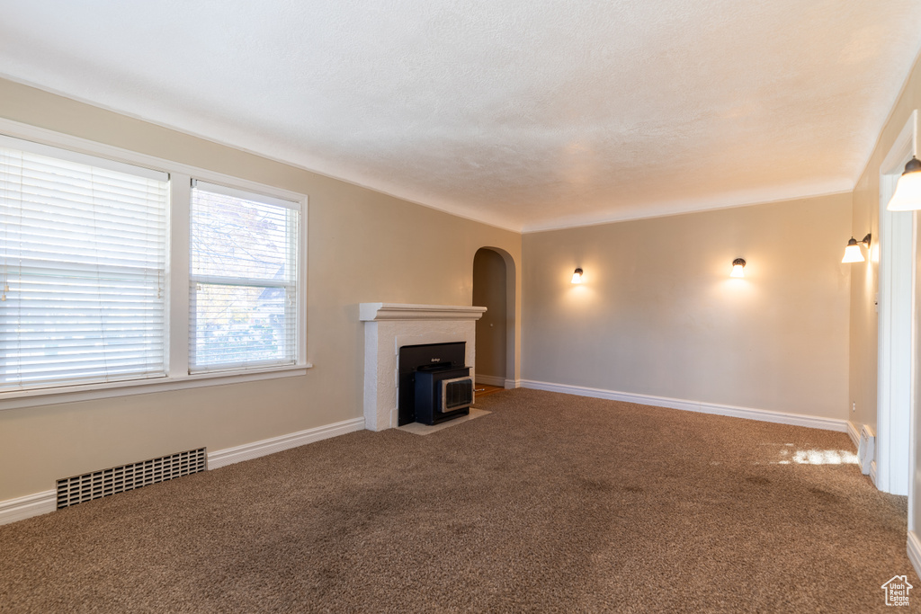 Unfurnished living room featuring carpet