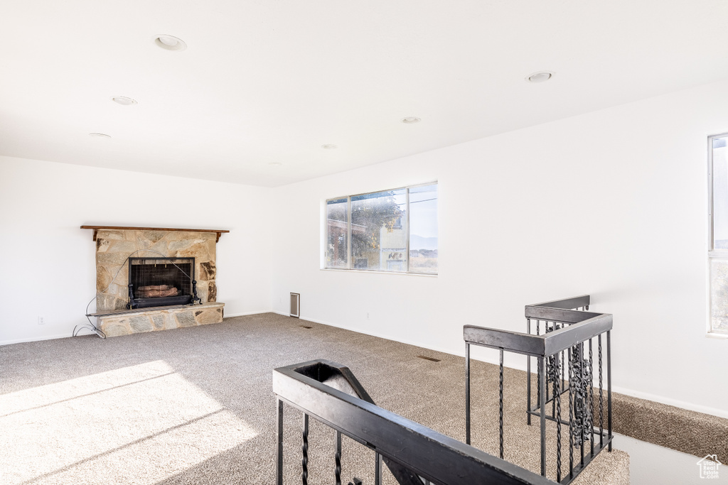 Living room featuring carpet and a fireplace