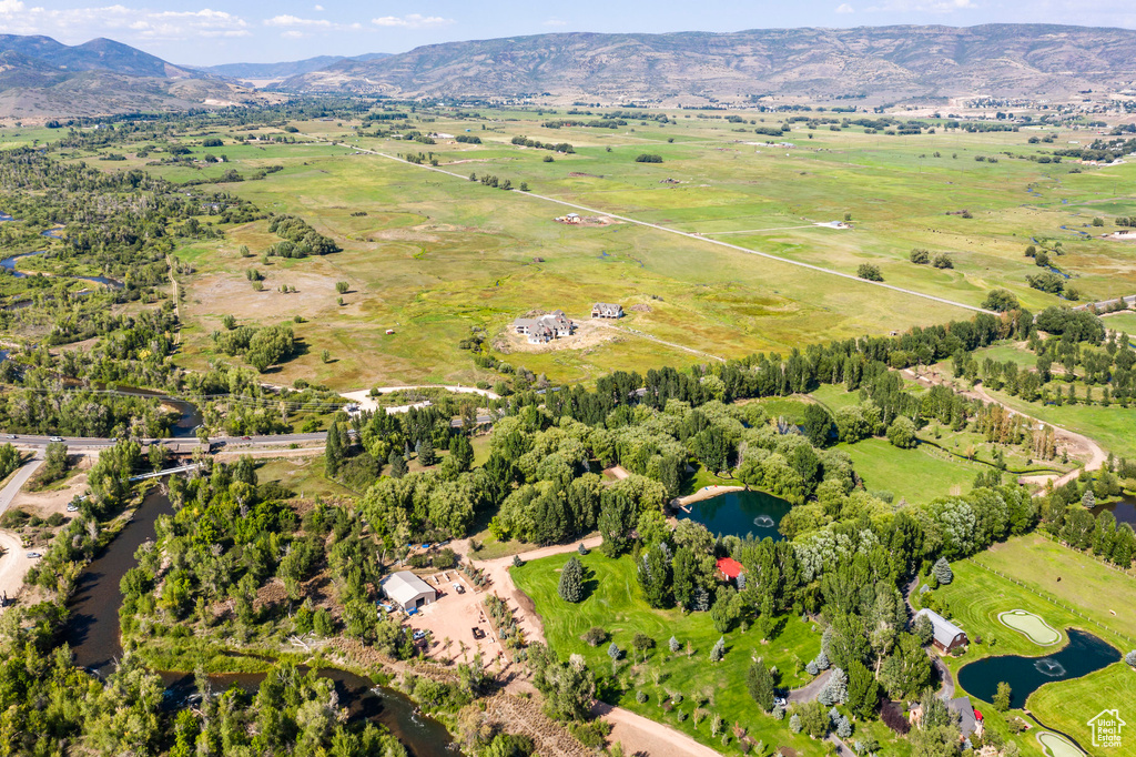 Aerial view with a water and mountain view and a rural view