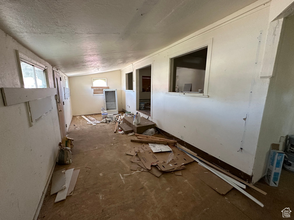 Miscellaneous room featuring lofted ceiling, a textured ceiling, and plenty of natural light