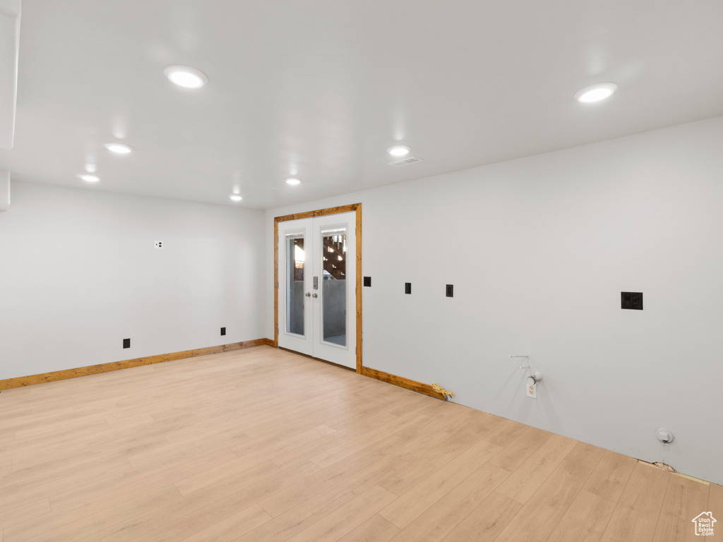 Spare room with light hardwood / wood-style flooring and french doors