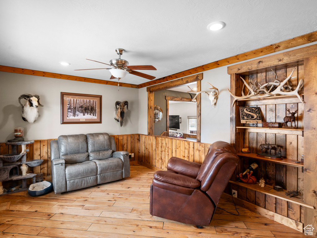 Living room featuring light hardwood / wood-style floors and ceiling fan