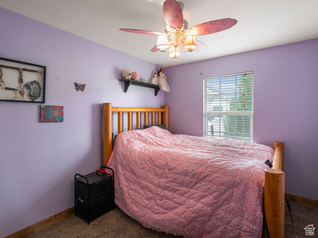 Bedroom featuring ceiling fan and carpet floors