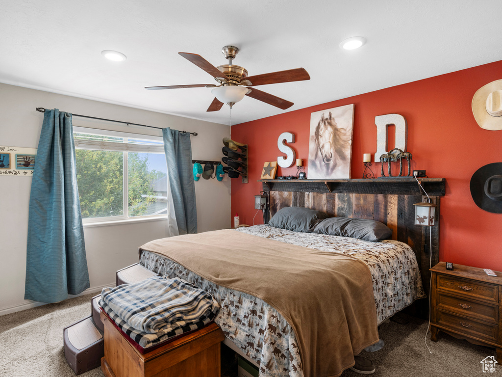 Carpeted bedroom with ceiling fan