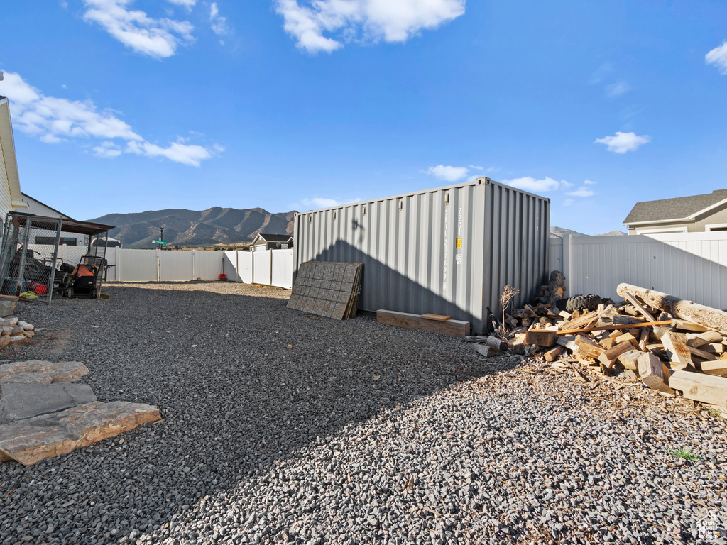 View of yard with a shed and a mountain view