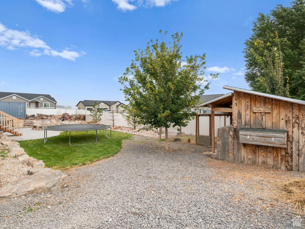 Exterior space with a trampoline and a shed