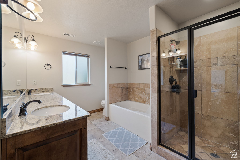 Full bathroom with toilet, tile patterned flooring, vanity, a chandelier, and independent shower and bath