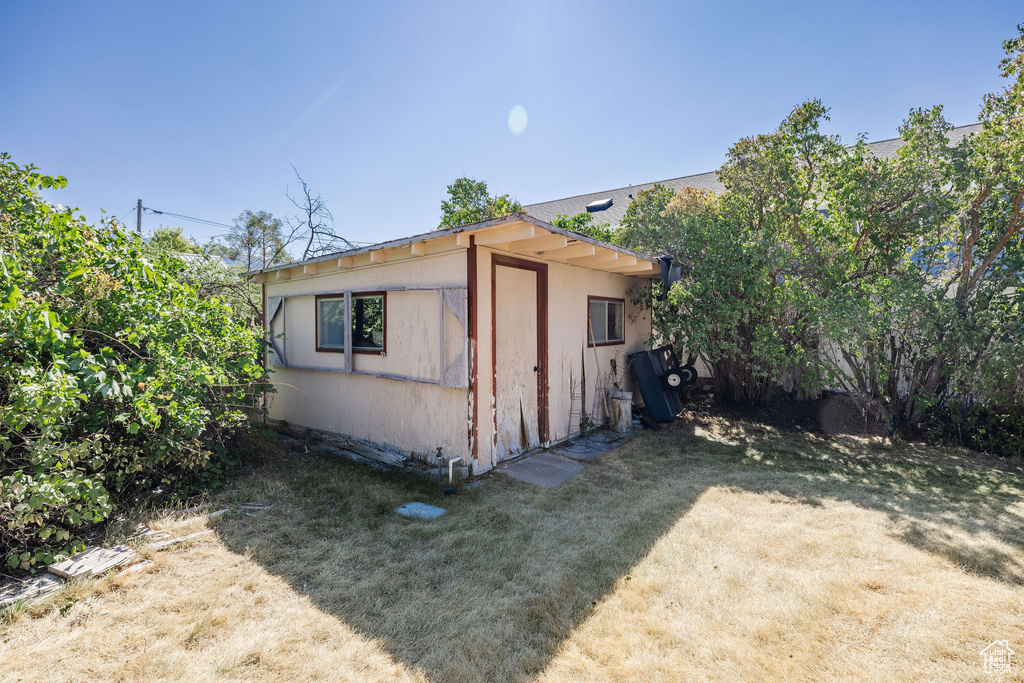 View of side of property with a lawn