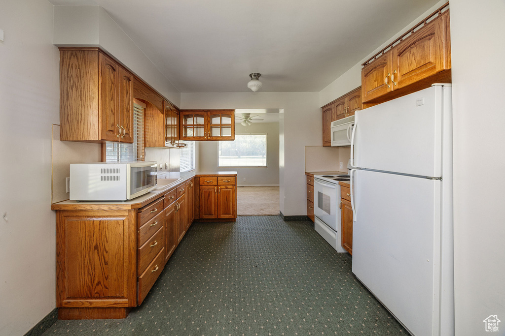 Kitchen with white appliances and sink