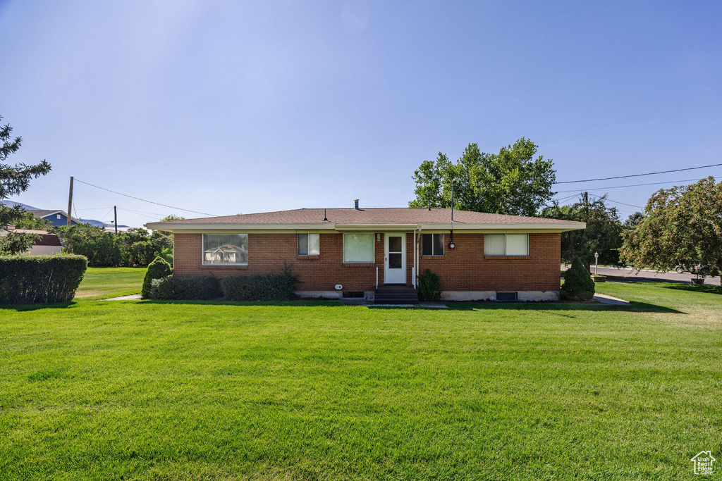 Rear view of property with a yard