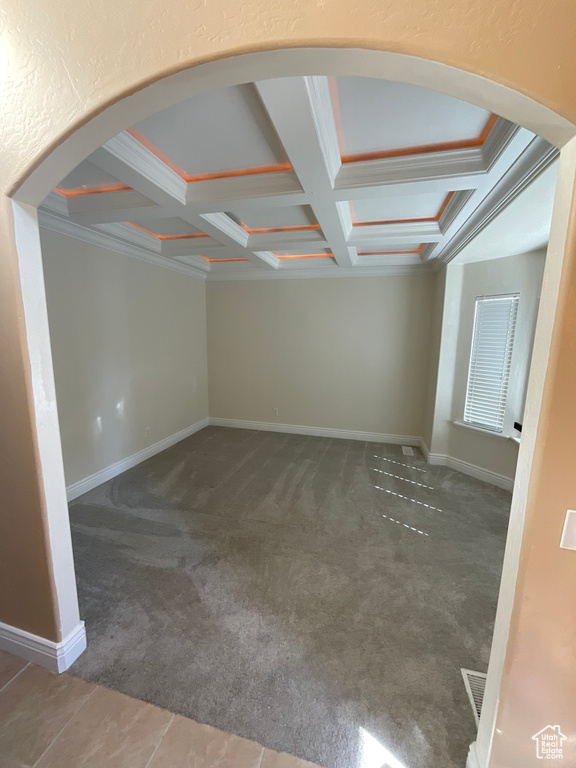 Carpeted spare room with coffered ceiling, ornamental molding, and beam ceiling