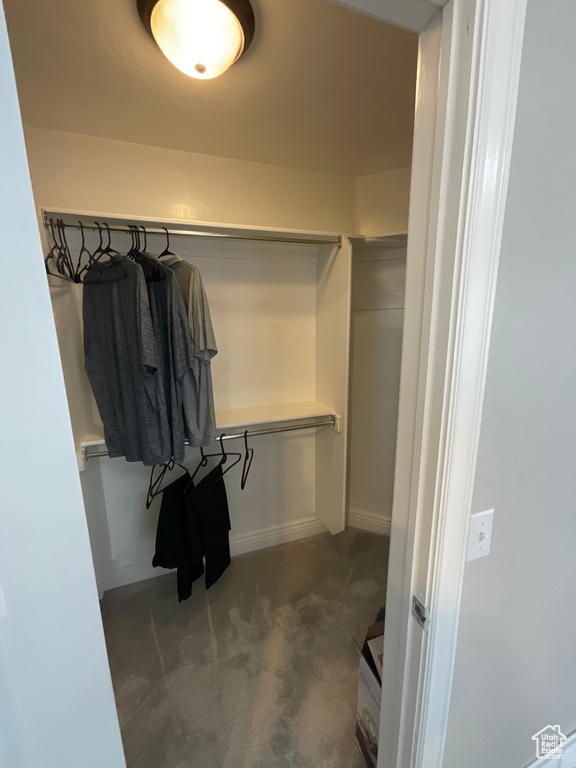 Spacious closet with dark carpet