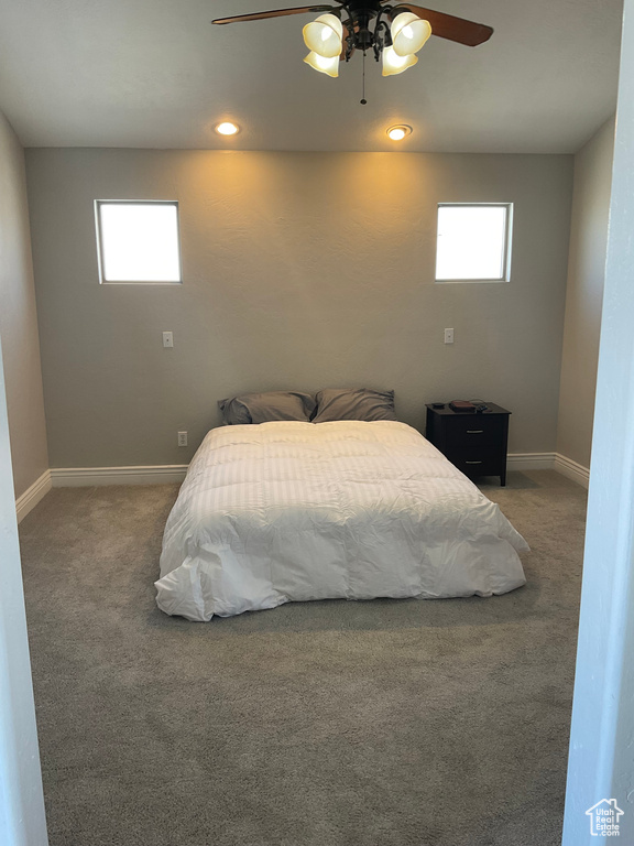 Carpeted bedroom with ceiling fan