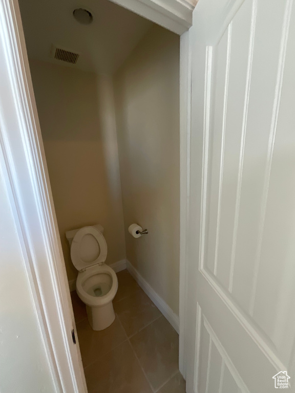 Bathroom featuring toilet and tile patterned floors