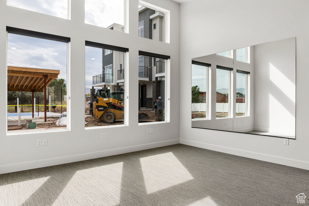 Interior space with a towering ceiling and carpet