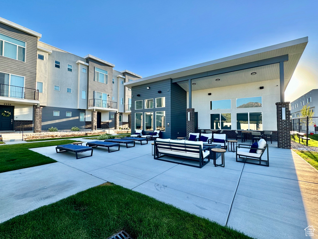 View of property's community with an outdoor living space and a patio area