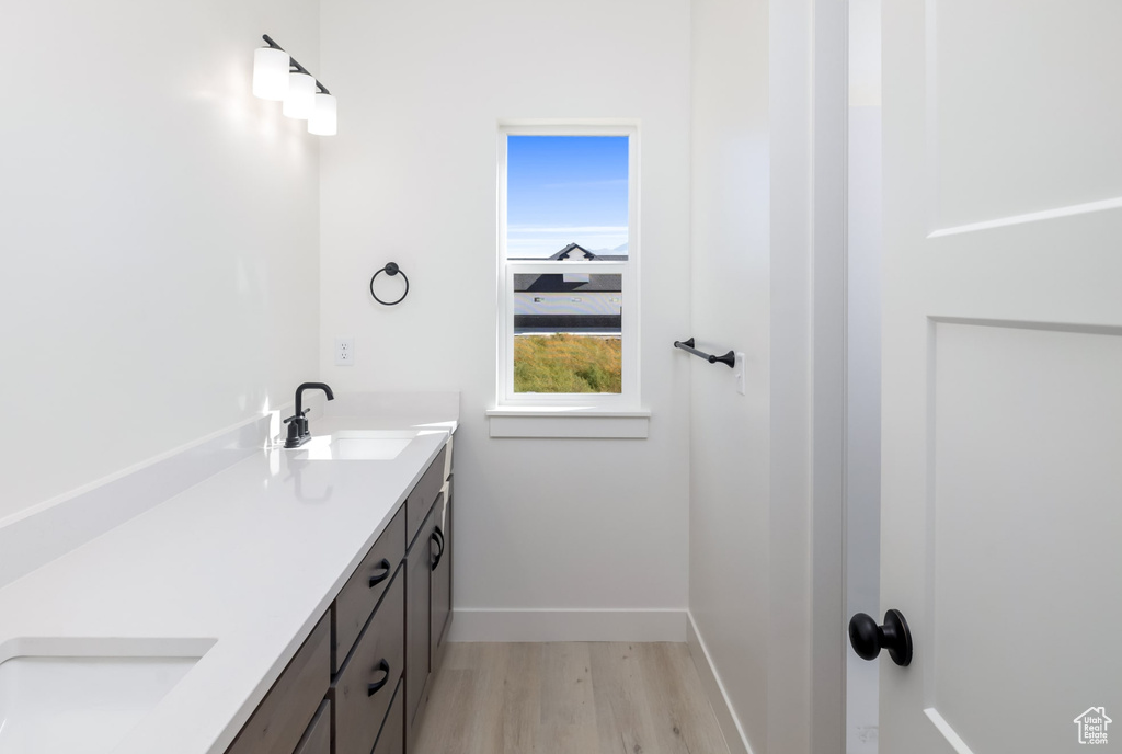 Bathroom with vanity and hardwood / wood-style flooring