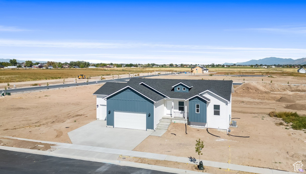 View of front of house with a mountain view and a garage