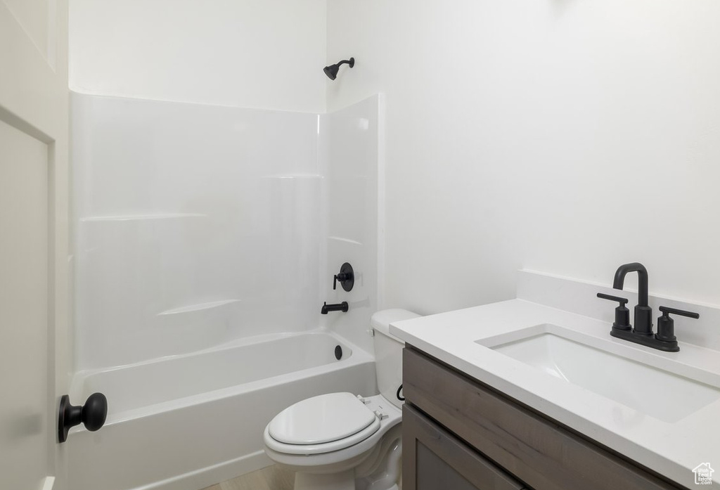 Full bathroom with bathing tub / shower combination, vanity, and toilet