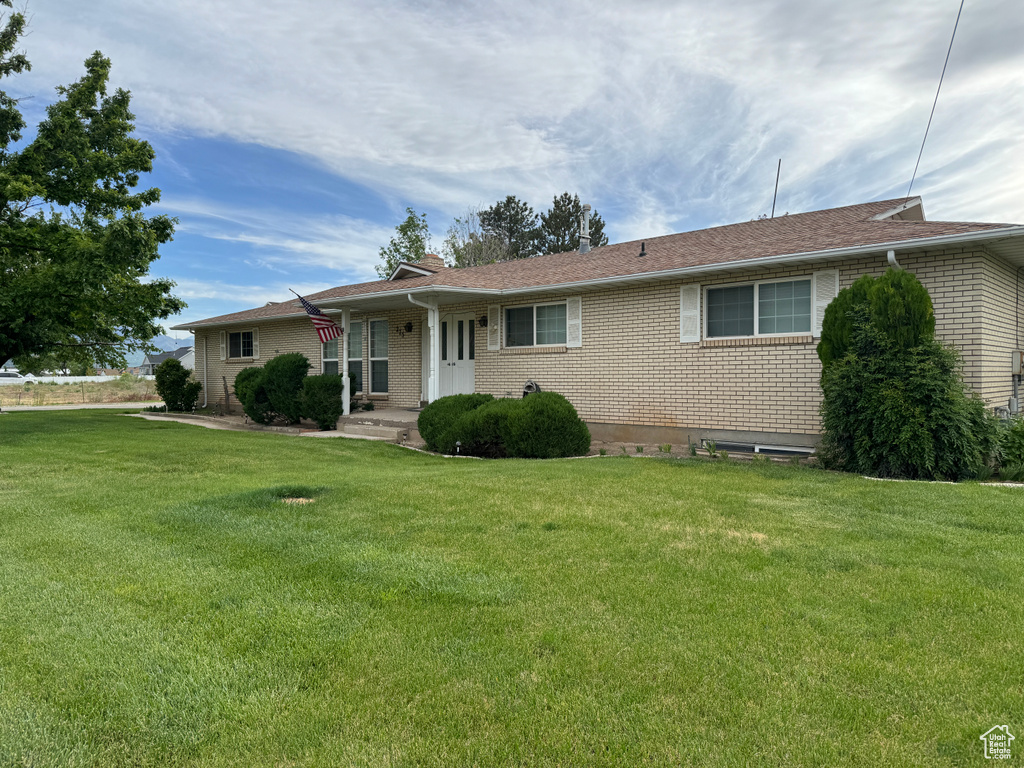 Ranch-style house featuring a front lawn