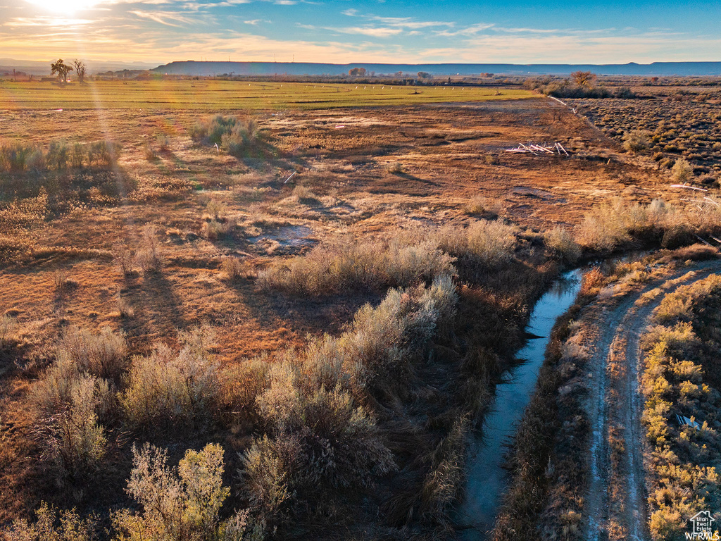 Aerial view at dusk featuring a rural view