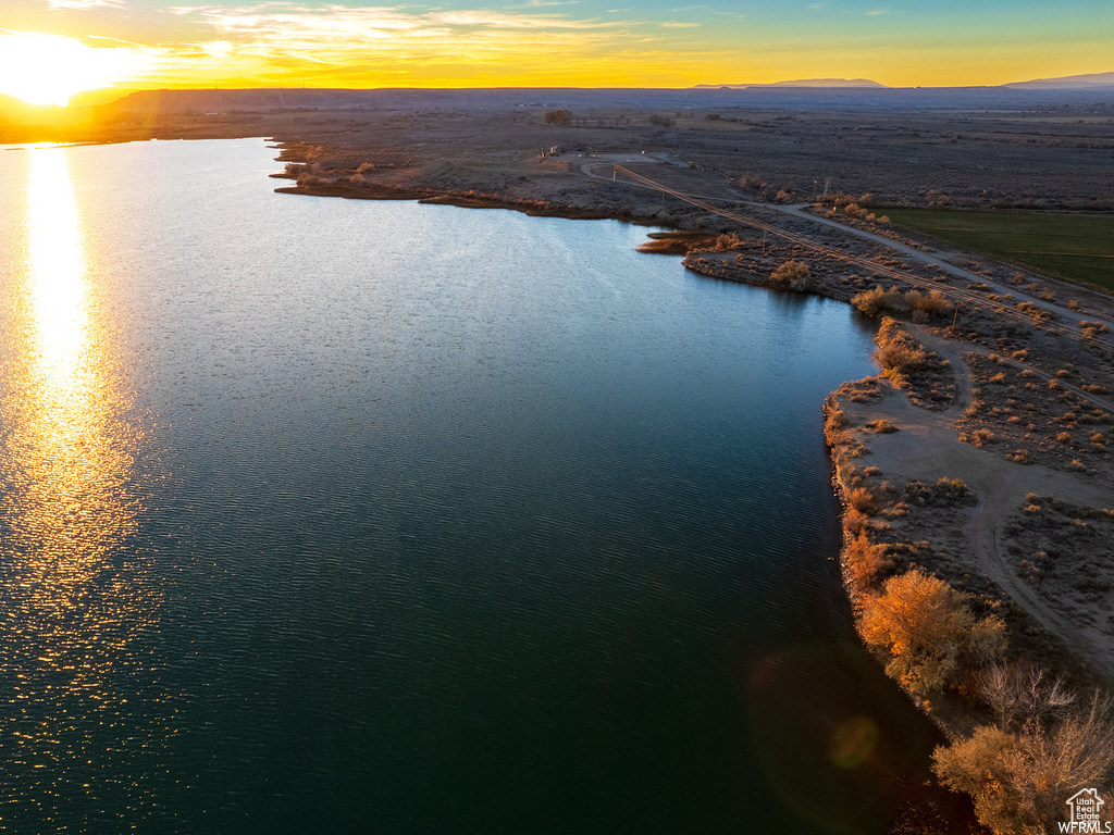 Aerial view at dusk featuring a water view