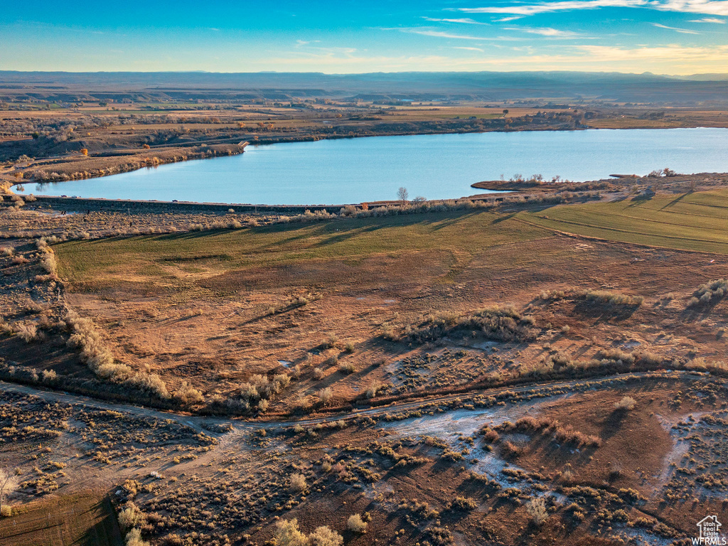 Birds eye view of property featuring a water view and a rural view