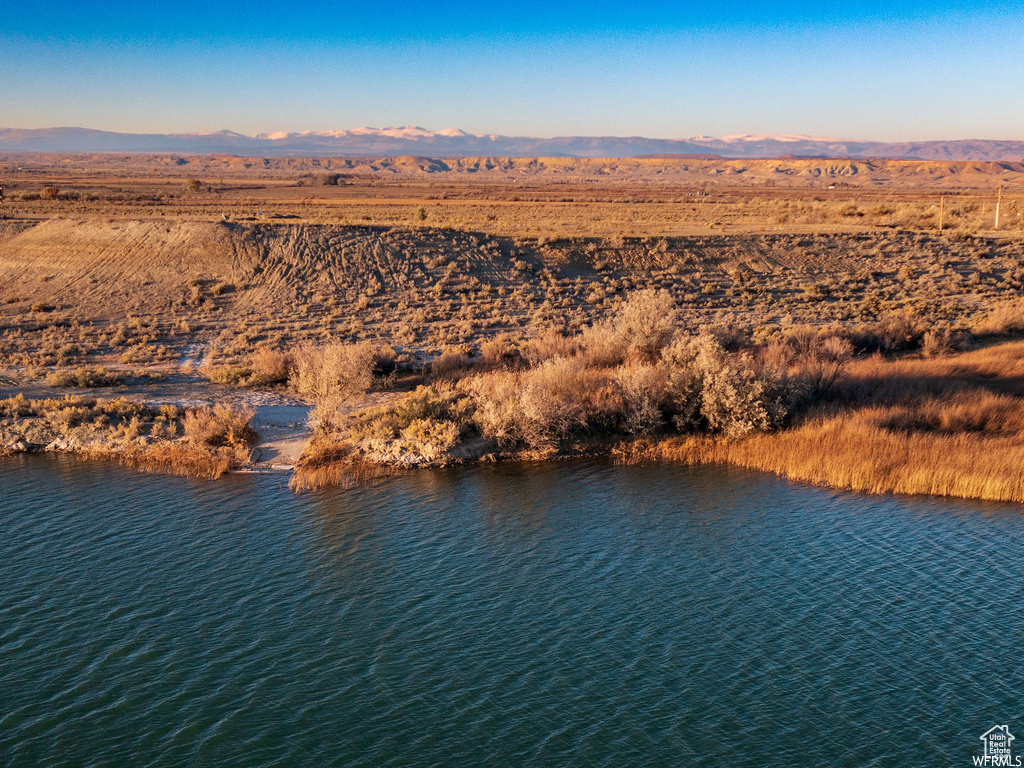 Birds eye view of property with a water and mountain view