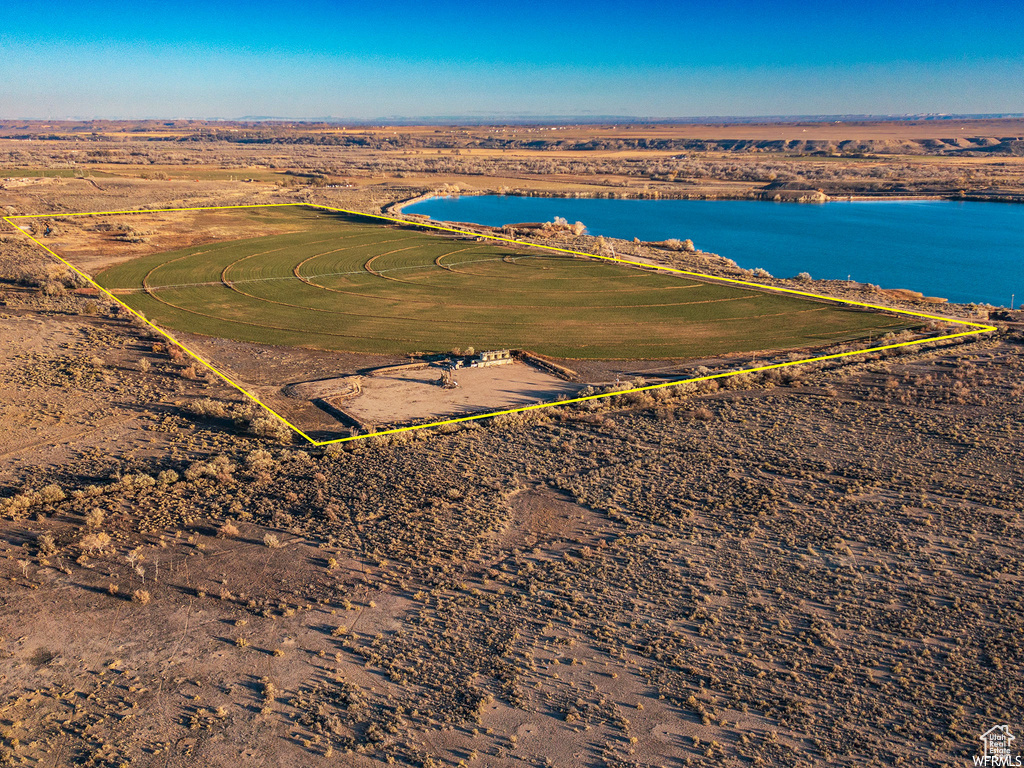 Birds eye view of property with a water view