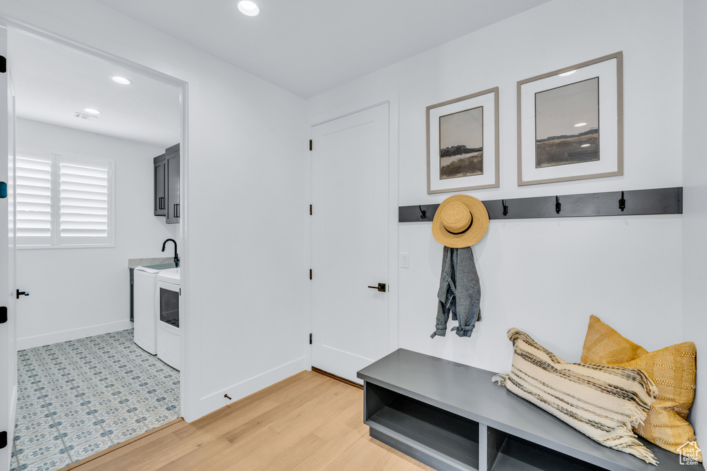 Mudroom featuring light hardwood / wood-style flooring and separate washer and dryer